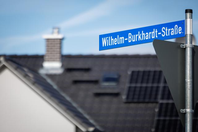 FILED - 13 February 2024, Bavaria, Allersberg: File Photo - A street sign displays the name "Wilhelm-Burkhardt-Strasse" in a newly developed residential neighborhood. Photo: Daniel Karmann/dpa