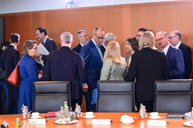 22 July 2026, Berlin: German Chancellor Friedrich Merz (C) speaks with members of the government before a Cabinet meeting. Photo: Sebastian Gollnow/dpa