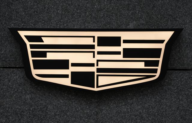 FILED - 28 November 2024, Hamburg: FILE PHOTO - The company logo of the US car manufacturer Cadillac can be seen in front of the Cadillac showroom in Hamburg city center. Photo: Marcus Brandt/dpa