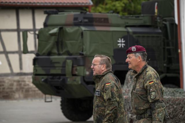 23 July 2026, Baden-Wuerttemberg, Hardheim: German Minister of Defense Boris Pistorius (L) and Colonel Roger Kahle-Specht, commander of Transport Helicopter Regiment 30 "Tauberfranken", walk in front of a military truck. Photo: Hannes P. Albert/dpa