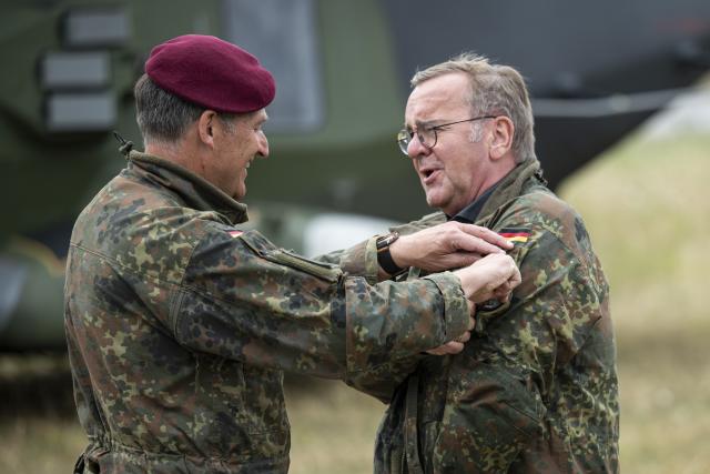 23 July 2026, Baden-Wuerttemberg, Hardheim: Colonel Roger Kahle-Specht, commander of Transport Helicopter Regiment 30 "Tauberfranken" removes a patch from the jacket of German Minister of Defense Boris Pistorius during his visit to Transport Helicopter Regiment 30. Photo: Hannes P. Albert/dpa