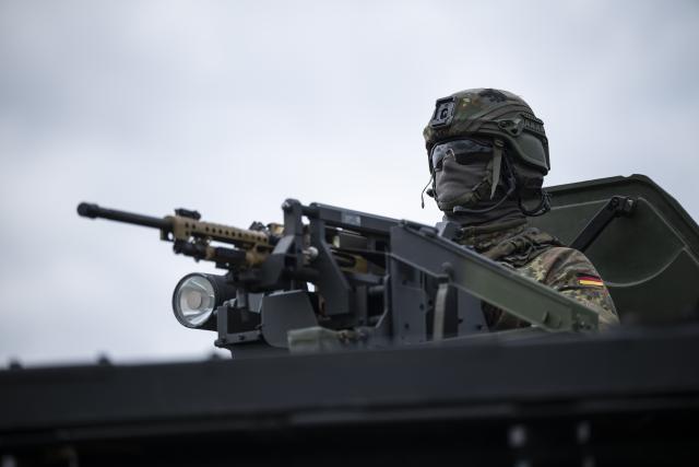 23 July 2026, Baden-Württemberg, Hardheim: A German Armed Forces (Bundeswehr) soldier looks out of a military vehicle. German Defense Minister Pistorius (SPD) wants to get a firsthand look at the capabilities of the Army Aviation Group based in Niederstetten. According to the Defense Ministry, the group is establishing a helicopter task force for NATO. Photo: Hannes P Albert/dpa