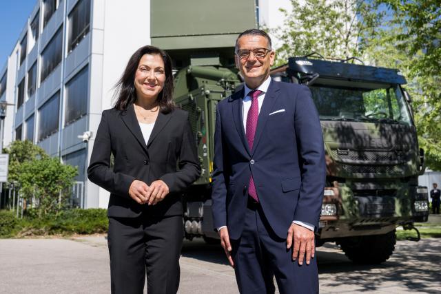 24 July 2026, Bavaria, Fuerstenfeldbruck: German Economic Affairs Minister Katherina Reiche and Hensoldt AG CEO Oliver Dorre stand in front of a vehicle equipped with a TRML-4D omnidirectional radar, at Hensoldt AG. Reiche is visiting the defence company as part of her trip to Bavaria. Photo: Tobias Hase/dpa