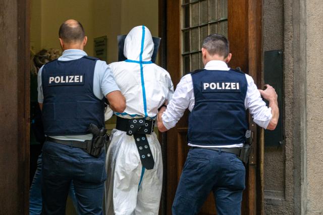 24 July 2026, Bavaria, Regensburg: The suspected perpetrator is brought before a magistrate, following the fatal knife attack at a bank in Regensburg. The criminal investigation department is continuing efforts to determine the circumstances surrounding the incident. Photo: Armin Weigel/dpa
