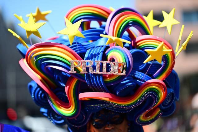25 July 2026, Berlin: The word "Pride" is written on a participant's headpiece as people march under the slogan "Attitude is hot" during Christopher Street Day (CSD). For the first time, Berlin's CSD is taking place over two days. Photo: Fabian Sommer/dpa
