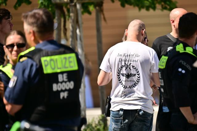 25 July 2026, Berlin: Far-right demonstrators are detained by police at Potsdamer Platz while on their way to a counter-demonstration against Christopher Street Day (CSD). The counter-demonstration is held under the slogan "We say 'No to CSD' - End the gender nonsense - There are only two genders: 'man and woman'." Photo: Sebastian Gollnow/dpa
