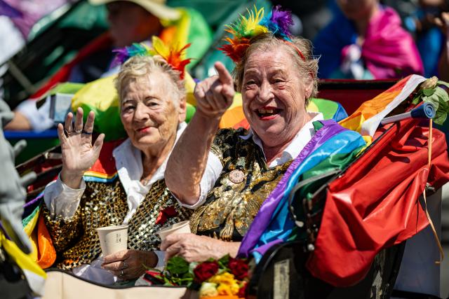 25 July 2026, Berlin: Two people sit in a rickshaw during the Christopher Street Day (CSD) parade under the theme "Attitude Is Hot." Photo: Fabian Sommer/dpa