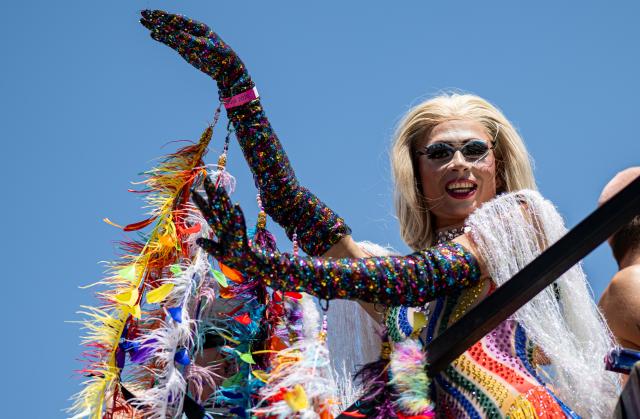 25 July 2026, Berlin: A person dances on a float during the Christopher Street Day (CSD) parade, held under the theme "Attitude Is Hot." Photo: Fabian Sommer/dpa