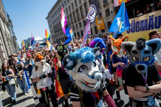 25 July 2026, Berlin: People wearing fursuit heads take part in the Christopher Street Day (CSD) parade under the slogan "Attitude Is Hot." Photo: Fabian Sommer/dpa