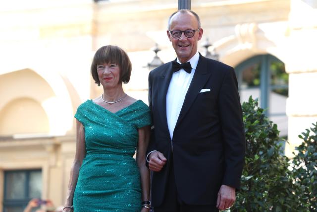 25 July 2026, Bavaria, Bayreuth: German Chancellor Friedrich Merz (R) and his wife, Charlotte Merz, arrive at the Festspielhaus for the opening of the Richard Wagner Festival. The Bayreuth Festival kicks off its 150th anniversary with Ludwig van Beethoven's Ninth Symphony. Photo: Karl-Josef Hildenbrand/dpa