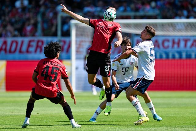 25 July 2026, Hesse, Wiesbaden: (L-R) Wehen Wiesbaden's Ibrahim Ati Allah, Moritz Flotho and Bayern Munich's Raphael Pavlic during the German Bundesliga Pre-season soccer match between SV Wehen Wiesbaden and FC Bayern Munich at BRITA Arena. Photo: Uwe Anspach/dpa - IMPORTANT NOTICE: Bundesliga and DFB regulations prohibit any use of photographs as image sequences and/or quasi-video.