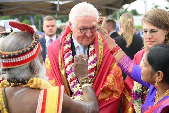 26 July 2026, North Rhine-Westphalia, Hamm: German President Frank-Walter Steinmeier (C) has a dot placed on his forehead at the Hindu community's grand temple festival in Germany. Photo: Federico Gambarini/dpa