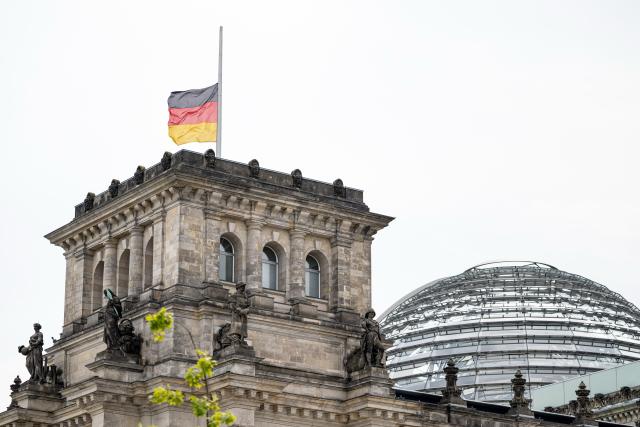 26 July 2026, Berlin: The German flag at the Reichstag building, home of the German Bundestag, flying at half-mast. On the sidelines of Christopher Street Day in Berlin, a vehicle plowed into a crowd. One woman was killed, and 16 others were injured, some seriously. Photo: Fabian Sommer/dpa