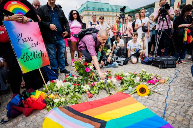 26 July 2026, Berlin: People take part in a demonstration in front of the Brandenburg Gate. Christopher Street Day in Berlin had been cut short the day before after a car plowed into a crowd on the outskirts of the large-scale event. Photo: Christoph Soeder/dpa