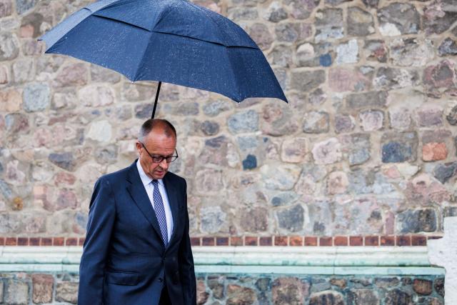 26 July 2026, Berlin: German Chancellor Friedrich Merz walks past St. Mary's Church after making a statement, after a vehicle had driven into a crowd of people on the sidelines of Christopher Street Day in Berlin. Photo: Christoph Soeder/dpa