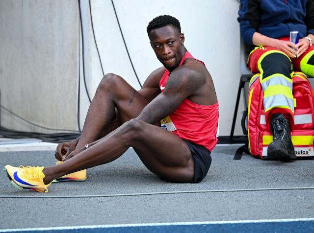 26 July 2026, North Rhine-Westphalia, Bochum: Germany's Owen Ansah sits in the stadium after the Men's 200-meter Final of the German Championships at Lohrheidestadion. Photo: Sven Hoppe/dpa