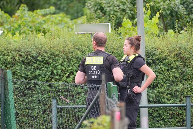 26 July 2026, Berlin: Police officers stand on the scene at an allotment garden community in Berlin-Spandau. According to information from security sources, one person was killed during a police operation in Spandau following the terrorist attack on the sidelines of Christopher Street Day (CSD). Photo: Michael Kappeler/dpa