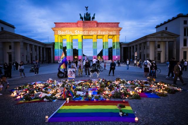 26 July 2026, Berlin: The Brandenburg Gate is illuminated in rainbow colors, displaying the words "Berlin, City of Freedom". Christopher Street Day in Berlin had been cut short the day before after a car plowed into a crowd on the outskirts of the large-scale event. Photo: Christoph Soeder/dpa