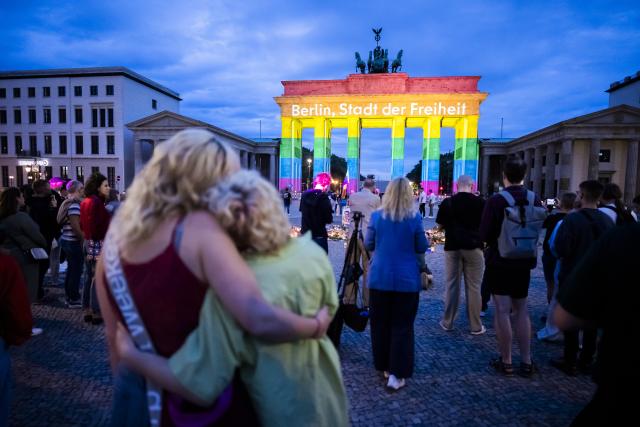 26 July 2026, Berlin: The Brandenburg Gate is illuminated in rainbow colors, displaying the words "Berlin, City of Freedom". Christopher Street Day in Berlin had been cut short the day before after a car plowed into a crowd on the outskirts of the large-scale event. Photo: Christoph Soeder/dpa