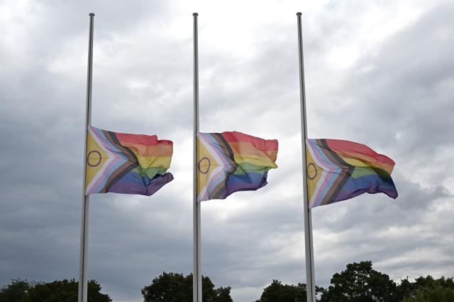 27 July 2026, Berlin: Three Progress Pride flags are flying at half-mast in front of the House of World Cultures, following the terrorist attack on the sidelines of Christopher Street Day (CSD) after a car plowed into a crowd. Photo: Markus Lenhardt/dpa