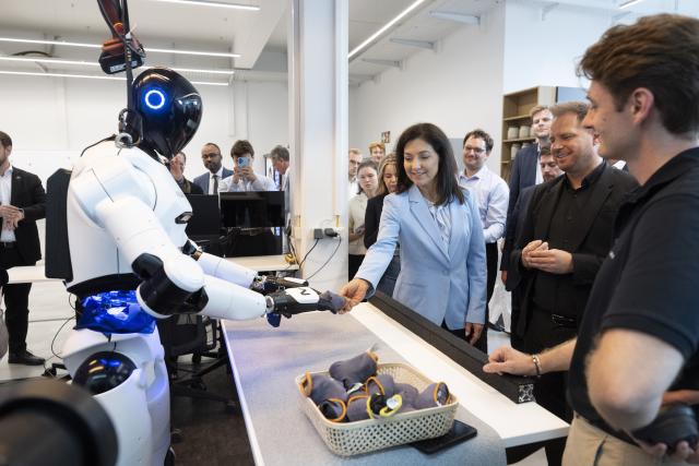 27 July 2026, Baden-Wuerttemberg, Metzingen: German Minister of Economic Affairs Katherina Reiche (C) and founder and CEO of Neura Robotics David Reger (2nd R) stand in front of a robot during Reiche's visit to Neura Robotics. Photo: Marijan Murat/dpa