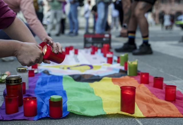 27 July 2026, Hesse, Frankfurt_Main: A person lights a candle at the memorial rally on Paulsplatz, following the attack on the outskirts of the Christopher Street Day (CSD) in Berlin. Photo: Andreas Arnold/dpa
