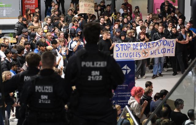 27 July 2026, Saxony, Schkeuditz: Participants in a left-wing demonstration gather inside a terminal at the Leipzig-Halle Airport. The activists organized the rally to protest an alleged deportation flight to Afghanistan. Photo: Sebastian Willnow/dpa