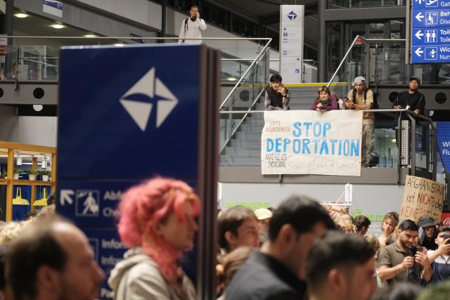 27 July 2026, Saxony, Schkeuditz: Participants in a left-wing demonstration gather inside a terminal at the Leipzig-Halle Airport. The activists organized the rally to protest an alleged deportation flight to Afghanistan. Photo: Sebastian Willnow/dpa
