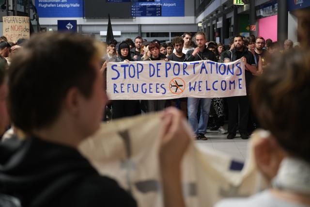 27 July 2026, Saxony, Schkeuditz: Participants in a left-wing demonstration gather inside a terminal at the Leipzig-Halle Airport. The activists organized the rally to protest an alleged deportation flight to Afghanistan. Photo: Sebastian Willnow/dpa