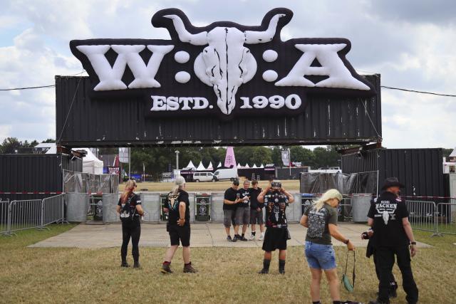 28 July 2026, Schleswig-Holstein, Wacken: Festivalgoers take photos in front of the Wacken Open Air logo. Photo: Frank Molter/dpa
