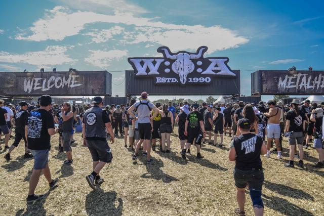 29 July 2026, Schleswig-Holstein, Wacken: Festivalgoers are lining up at an entrance to the Wacken Open Air (W:O:A). The W:O:A is considered the world's largest heavy metal festival. Photo: Frank Molter/dpa