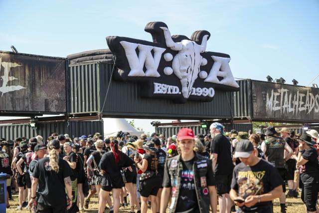 29 July 2026, Schleswig-Holstein, Wacken: Festivalgoers are lining up at an entrance to the Wacken Open Air (W:O:A). The W:O:A is considered the world's largest heavy metal festival. Photo: Frank Molter/dpa