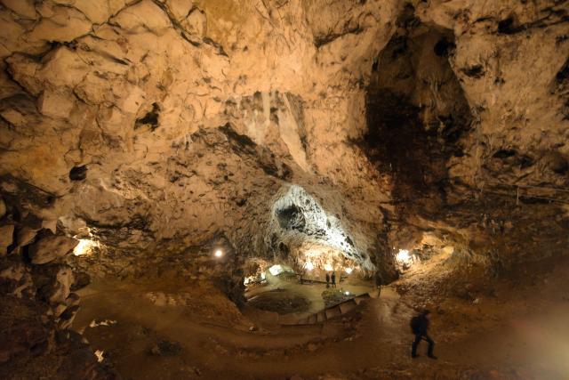 FILED - 20 May 2017, Baden-Wuerttemberg, Blaubeuren: FILE PHOTO - Visitors walk through the the 'Hohler Fels' cave in Schelklingen. Photo: picture alliance / Stefan Puchner/dpa
