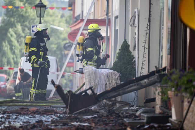 30 July 2026, Hesse, Lauterbach (Hessen): Firefighters conduct mop-up operations, after a major blaze damaged several half-timbered houses. Initial estimates by the local fire department indicate that the fire in the central German state of Hesse caused at least five million euros in property. Photo: Florian Wiegand/dpa