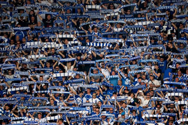 FILED - 03 May 2026, Saxony-Anhalt, Magdeburg: FILE PHOTO - Fans of 1. FC Magdeburg hold up scarves in support of their team during the Bundesliga 2 match between 1. FC Magdeburg and Hertha BSC at Avnet Arena. Photo: Julius Frick/dpa - IMPORTANT NOTE: In accordance with the regulations of the DFL German Football League and the DFB German Football Association, it is prohibited to utilize or have utilized photographs taken in the stadium and/or of the match in the form of sequential images and/or video-like photo series.