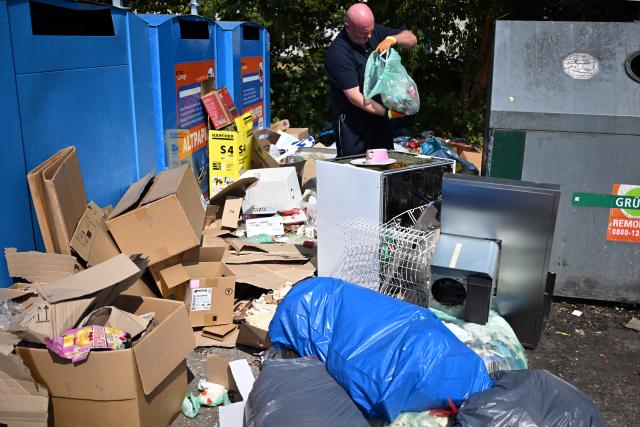 30 July 2026, North Rhine-Westphalia, Bonn: Waste investigator Frank Schaar searches through illegally dumped garbage for identification clues at a site. The city is deploying specialized "trash detectives" to inspect illicit disposal sites and trace perpetrators, an escalating issue currently impacting municipal services across the western German state of North Rhine-Westphalia. Photo: Federico Gambarini/dpa