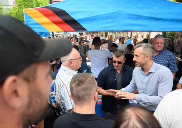 31 July 2026, Saxony-Anhalt, Bitterfeld-Wolfen: Ulrich Siegmund, the AfD's top candidate in Saxony-Anhalt, is talking at his party's information booth on the market square in Bitterfeld. The AfD is leading in the polls for the state election. Voters in Saxony-Anhalt will elect a new state parliament on September 6. Photo: Hendrik Schmidt/dpa