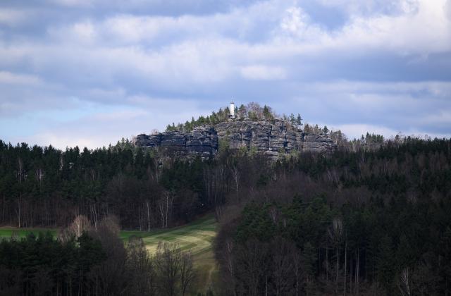 FILED - 01 April 2025, Saxony, Cunnersdorf: File Photo - The sun shines on the Papststein table mountain in the afternoon in the Saxon Switzerland National Park. Photo: Robert Michael/dpa