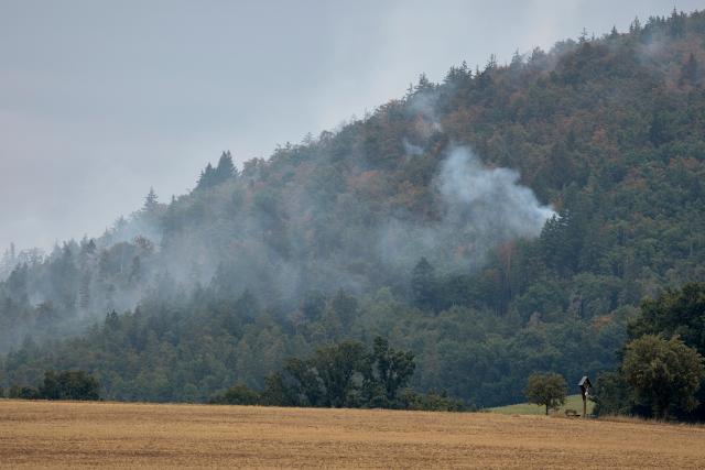 01 August 2026, Bavaria, Freudenberg: Police helicopters are attempting to contain a wildfire in the Amberg-Sulzbach district. Four firefighters were injured while battling the wildfire. Photo: Tizian Gerbing/dpa