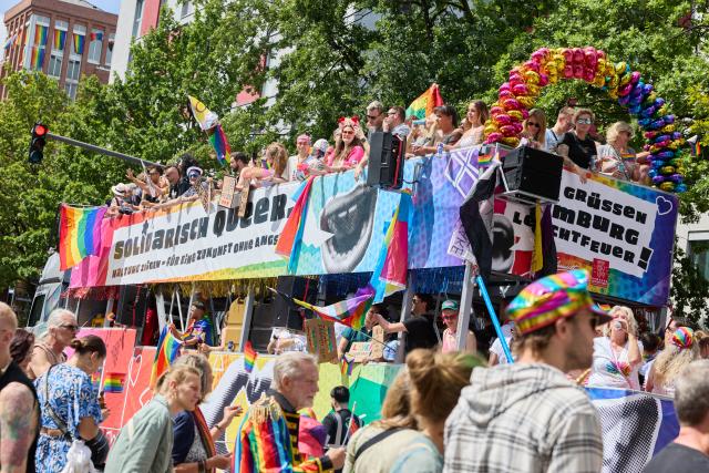 01 August 2026, Hamburg: A truck from the Schmidt Theater bearing the slogan "Queer in Solidarity. Take a Stand-for a Future Without Fear!" drive down Steindamm during Hamburg Pride 2026, the Christopher Street Day (CSD) parade. Photo: Georg Wendt/dpa