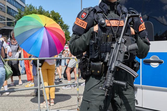 01 August 2026, Hamburg: A police officer stands on Steindamm at the edge of Hamburg Pride 2026, the Christopher Street Day (CSD) parade. Photo: Georg Wendt/dpa