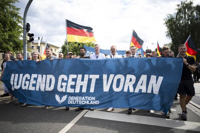 01 August 2026, Mecklenburg-Western Pomerania, Schwerin: Demonstrators from the Alternative for Germany (AfD) youth organization Generation Deutschland march through downtown Schwerin during a protest to mark "German Youth Day". Photo: Philip Dulian/dpa