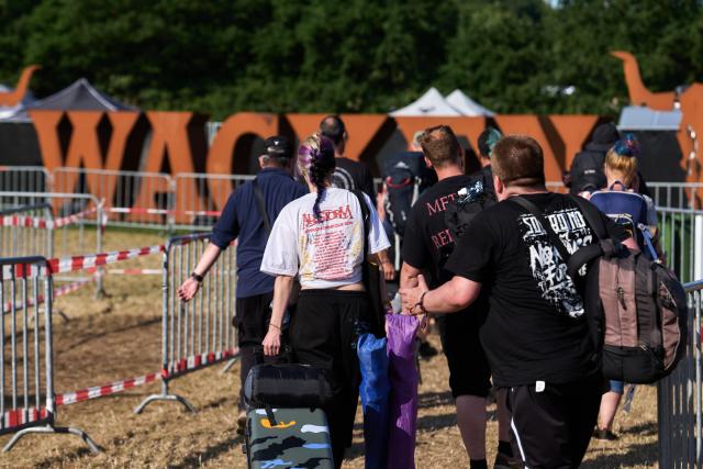 02 August 2026, Schleswig-Holstein, Wacken: Festivalgoers leave the Wacken Open Air (W:O:A) festival. Wacken Open Air is considered the world's largest heavy metal festival. Photo: Marcus Golejewski/dpa