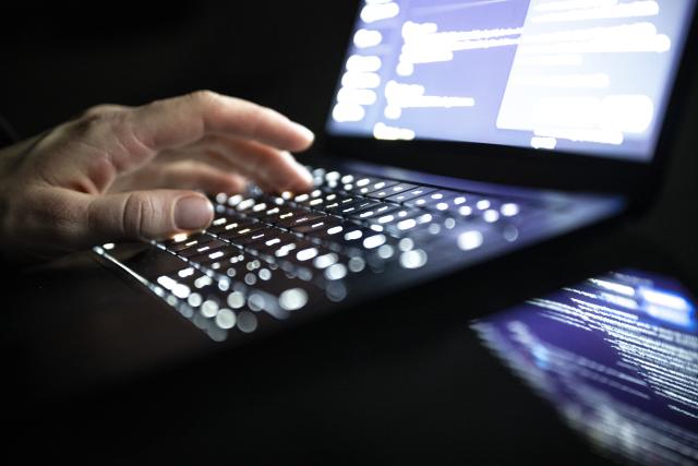 FILED - 14 December 2025, Berlin: FILE PHOTO - A person types with his fingers on an illuminated laptop keyboard. Photo: Philip Dulian/dpa