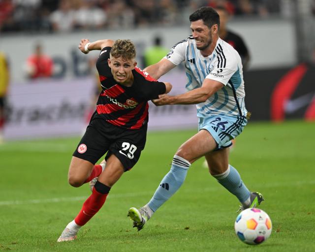 FILED - 04 August 2023, Hesse, Frankfurt/Main: FILE PHOTO - Frankfurt's Jesper Lindstroem (L) and Nottingham's Scott McKenna battle for the ball during the German Bundesliga soccer match between Eintracht Frankfurt and Nottingham Forrest at Deutsche Bank Park. Photo: Arne Dedert/dpa