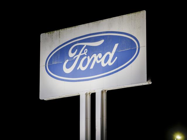 FILED - 08 December 2025, North Rhine-Westphalia, Cologne: FILE PHOTO - A logo of the car manufacturer Ford can be seen on a large sign of the Ford plant in Cologne. Photo: Thomas Banneyer/dpa