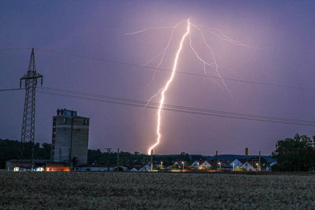 04 August 2026, Baden-Wuerttemberg, Dornstadt: A flash of lightning illuminates the sky over Dornstadt during a summer evening thunderstorm. Photo: Alexander Wolf/onw-images/dpa