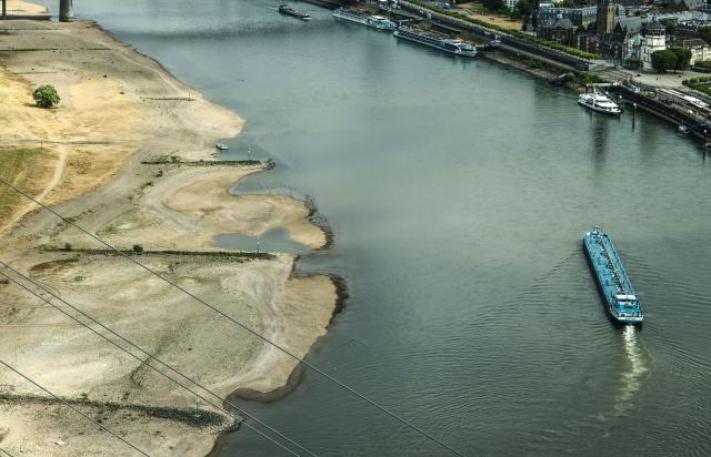 05 August 2026, North Rhine-Westphalia, Duesseldorf: An inland waterway vessel carrying a light load passes by Duesseldorf, the capital of North Rhine-Westphalia, at the Rhine Bend, during low water. Photo: Oliver Berg/dpa