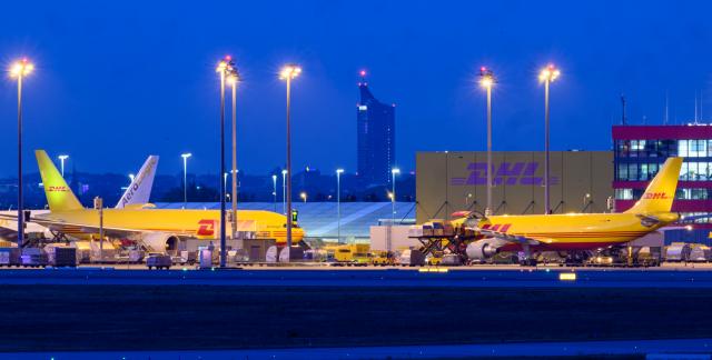 07 August 2026, Saxony, Schkeuditz: DHL aircraft are parked at Leipzig/Halle Airport. An investigation is underway following a drone incident early on Wednesday. According to security sources, a drone carrying an explosive device was seized near a Ukrainian transport aircraft. Security authorities are on high alert. Photo: Hendrik Schmidt/dpa