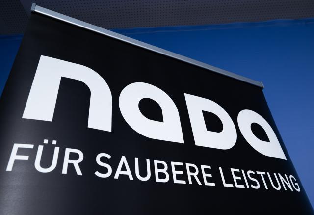 FILED - 09 June 2026, Berlin: FILE PHOTO - A roll-up with the slogan "For clean performance" is displayed on a wall before the start of NADA's annual press conference. Photo: Soeren Stache/dpa